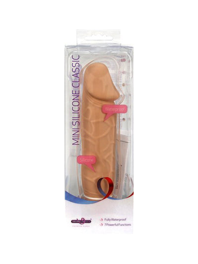 Displaying the product in the packaging. Packaging is a clear plastic which showcases the vibrator with purple writing on the left side going from bottom up that states "Mini Silicone Classic", pink word bubbles on the middle right and lower bottom left that say "Waterproof" and "Silicone" and at the bottom on a white background states the company's name, and two other features of the product.